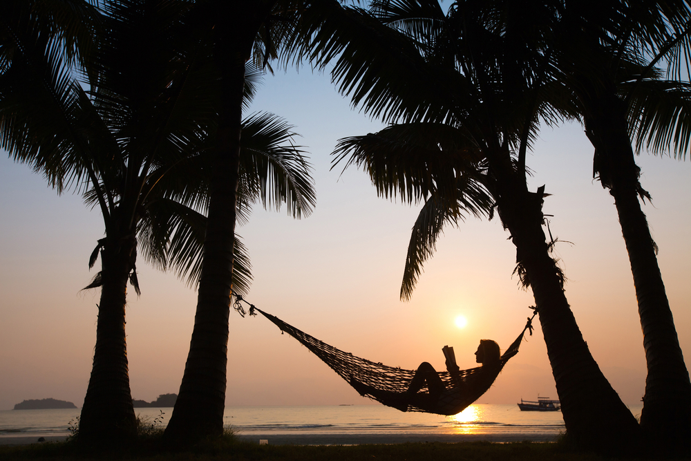 Sleep while on vacation.  Relaxing in a hammock.