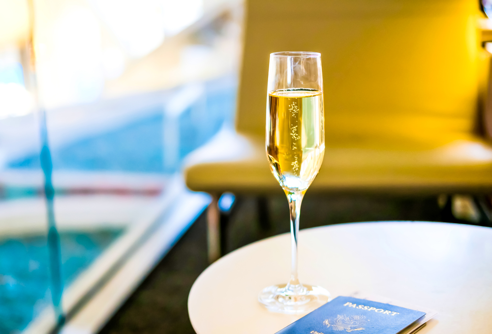 Airport Anxiety.   Glass of champagne and a passport.