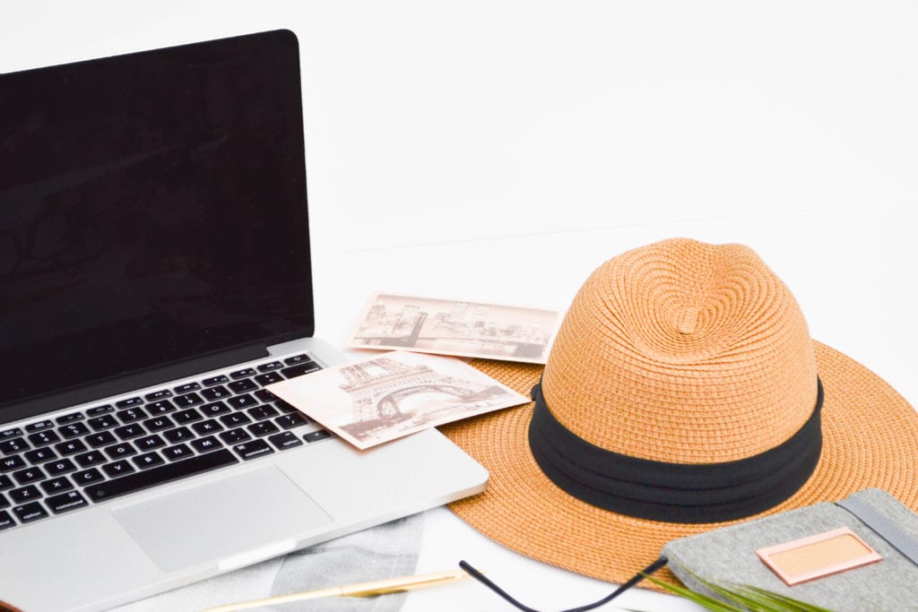 TRavel Blogging Course.  Laptop, postcards and straw hat