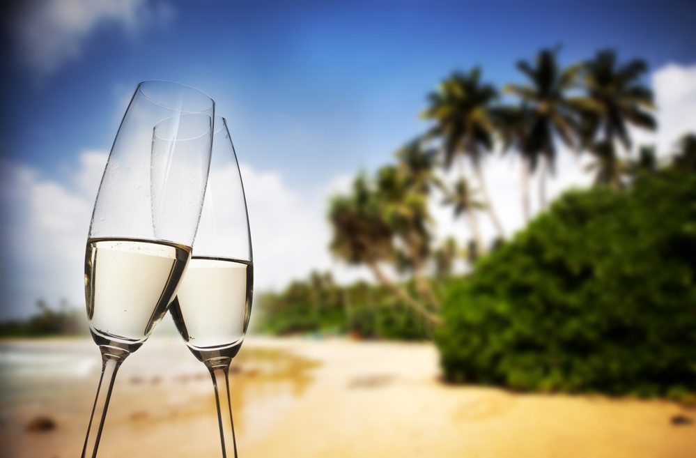 I miss traveling.
Champagne glasses on tropical beach at sunset - exotic New Year