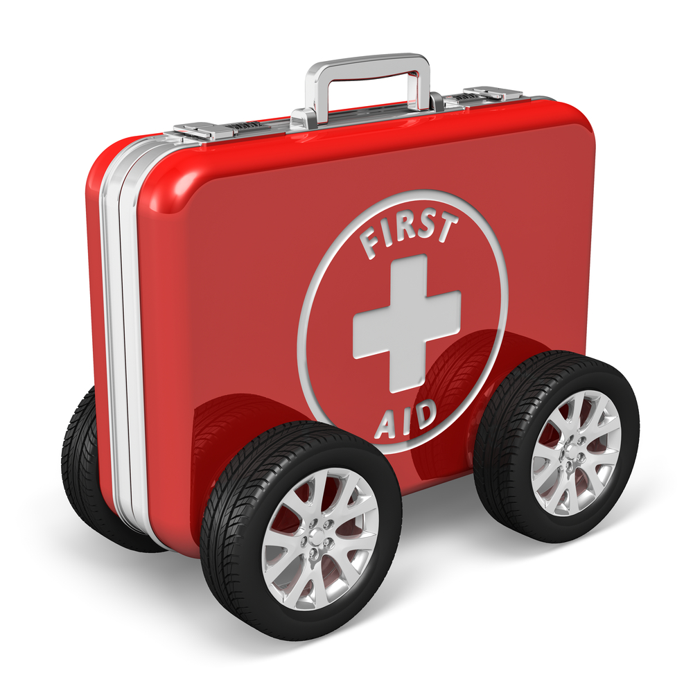 car survival kit
Medical assistance concept: red case with first aid kit with car wheels isolated on white background