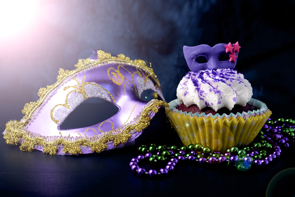 Mardi Gras cupcakes with small mask toppers made from confectionery sugar, against a vivid blue background.
Travel Blog Post Ideas.
