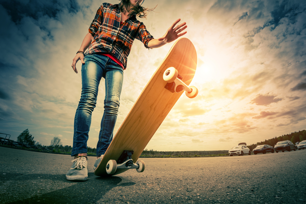 Summer Bucket List Ideas for Teens.
Young lady with skateboard on the road