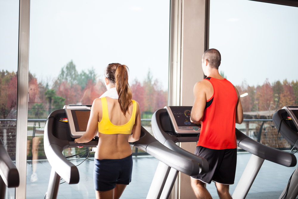 Running While Traveling.
People running on treadmills in a fitness club.