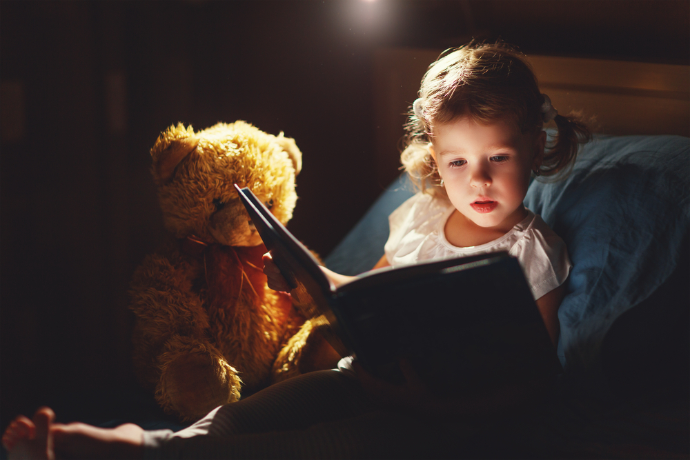 How to Get Over Jet Lag.
child girl reading a book in bed before going to sleep