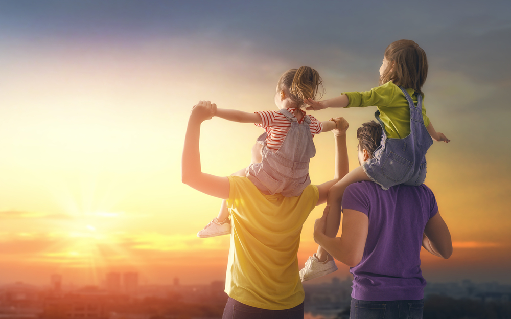 Traveling with Family Quotes.
happy family at sunset. father, mother and two children daughters having fun and playing in nature. the child sits on the shoulders of his father.