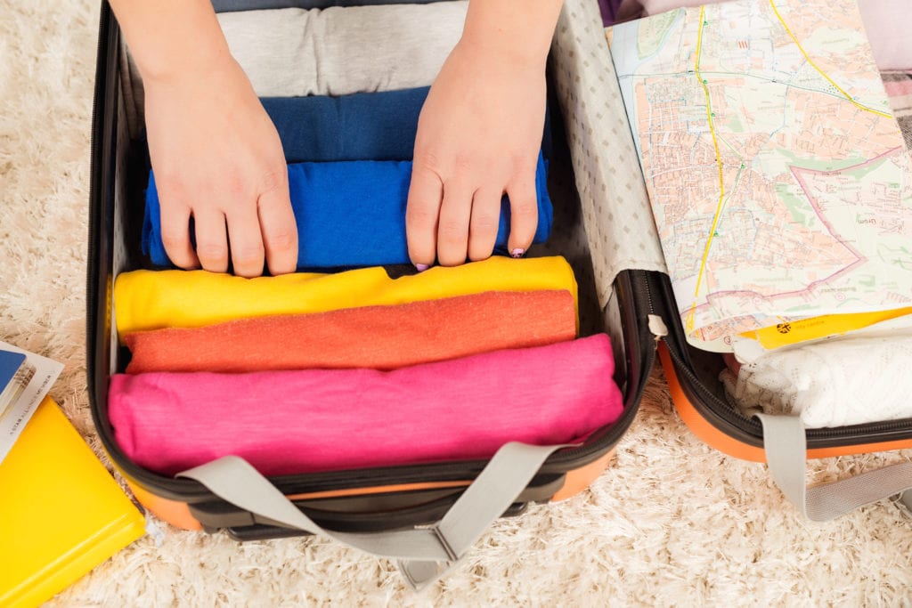 Packing Hacks for Moms.
Woman packing a luggage for a trip.