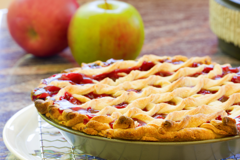 Christmas Bucket List Ideas.
Homemade cherry pie cooling with fruit in the background