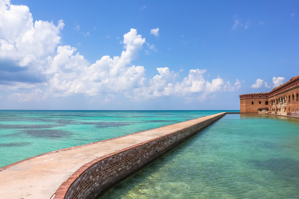25+ Fun Things to do in Key West Florida.  The Northern Side of Fort Jefferson on Dry Tortugas National Park, Florida. Concrete Walkway around Fort Jefferson with the crystal clear waters of the Gulf of Mexico surround it.